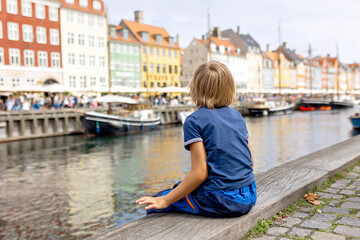 Family with children and pet dog, kids and adults visiting Coppenhagen , capital city of Denmarn during summer
