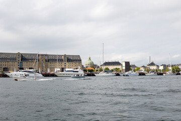 Family with children and pet dog, kids and adults visiting Coppenhagen , capital city of Denmarn during summer