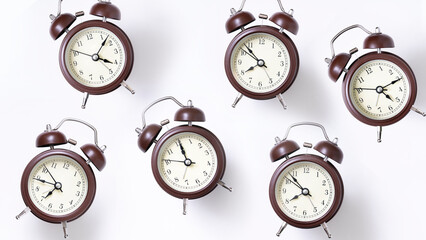 Random pattern of alarm clocks on a white background