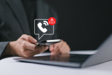 Phone scam alert notification concept. Woman holding a smartphone with a digital scam warning notification, fraudulent calls, cybersecurity threats, and telecommunication security awareness. fraud,