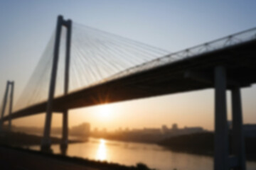 Obraz premium blurry photo of bridge in the afternoon showing beautiful sunset radiating from the corner of the bridge