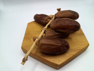Date palm fruit on serving board. This is the edible, sweet fruit produced by the date palm tree