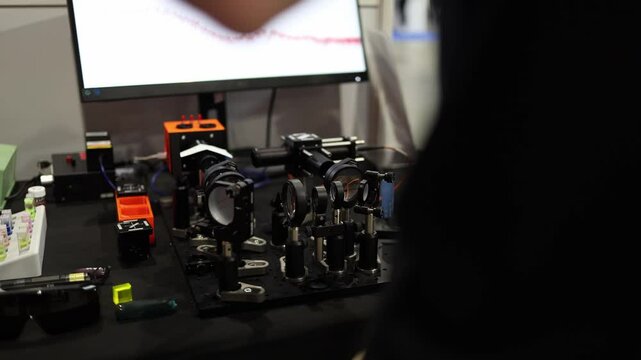 Precision optical lab setup with lenses mirrors and sensors mounted on a laser bench used for beam alignment spectroscopy or photonics research in advanced scientific and engineering environments
