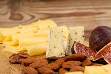 Cheese plate of color cheeses variety, yellow, white and blue cheese board, assorted dairy products