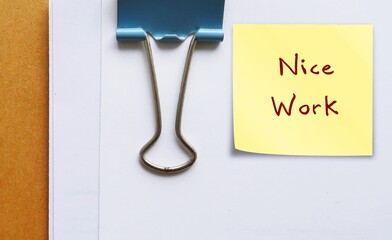 Document with compliment note NICE WORK  - giving positive feedback in response to a job well done...