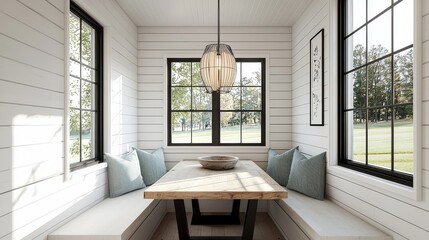 Modern farmhouse dining nook with white oak flooring, black windows, light blue-green pillows, square wood table, white shiplap walls, and willow pendant chandelier