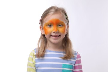 Cute girl with orange face painting on white background