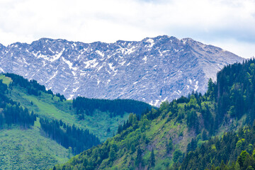 Fototapeta premium Alpine mountain range hill landscape peak panorama with snow Austria.