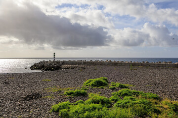 Lighthouse and Admiral Reis Beach in  Funchal, Madeira, Portugal 
