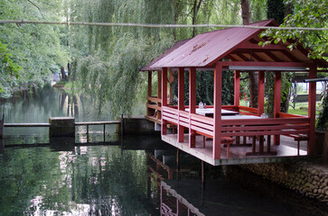 old wooden house on the water, gazebo