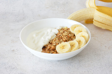 Healthy Breakfast Bowl with oat flakes, Yogurt and Banana Slices