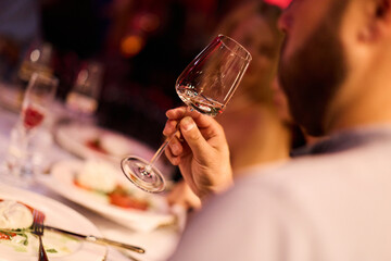 Elegant man holding wine glass