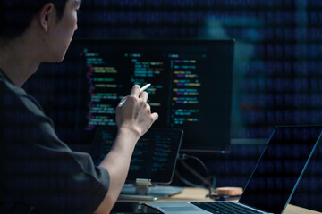 Hacking and malware concept. Hacker using abstract laptop with binary code digital interface.