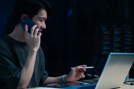 Hacking and malware concept. Hacker using abstract laptop with binary code digital interface. - Powered by Adobe