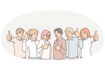 Team of promising people showing thumbs up as sign of desire to work together and achieve success