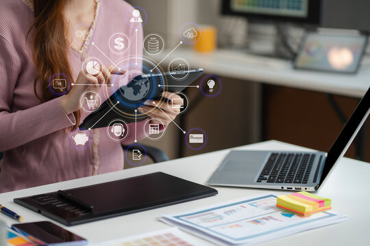 Female coder or developer working  using a Tablet and computer display in problem solving at workplace.
