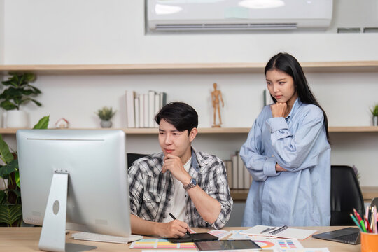 UX and UI Collaboration. Two designers discussing project ideas in a creative workspace.