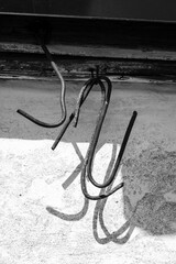 Bent iron whispers tales of forgotten purpose, its stark silhouette etched in monochrome against a...