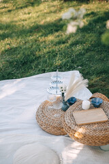 Outdoor picnic setup with woven decor and light refreshments on a sunny day