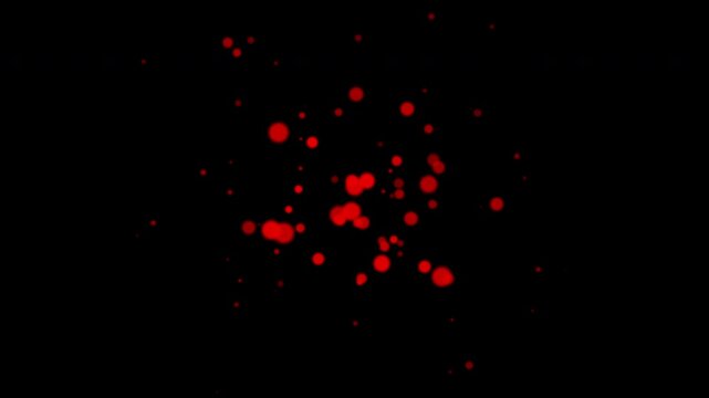 Red bubble particles fly in slow motion in the air black background 