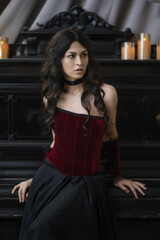 Portrait of a girl in a vintage corset at the piano