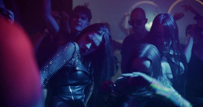 Creative People Move to Energetic Techno Rhythms in a Dark, Color-Filled Club with Flashing Stroboscopes. Cinematic Slow Motion Footage Celebrating Nightlife, Youth Culture, Freedom and Urban Energy