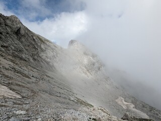 Panoramic view of Logarska dolina valley with peaks of Slovenian Alps covered by passing clouds.