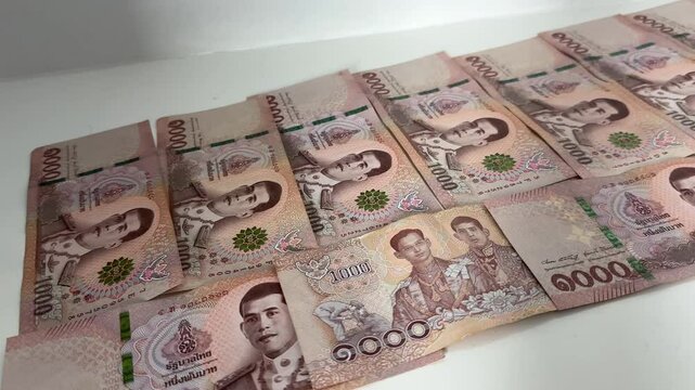 Close up shot of Thai baht Thailand cash currency THB bills and bank notes money economy