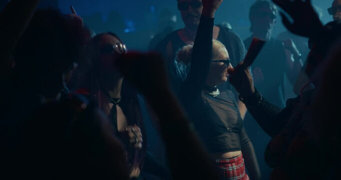 Creative People Move to Energetic Techno Rhythms in a Dark, Color-Drenched Club with Flashing Stroboscopes. Cinematic Slow Motion Footage Celebrating Nightlife, Youth Culture, Freedom and Urban Energy