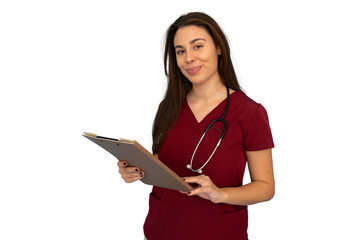 Young female doctor wearing maroon scrubs and stethoscope, holding a clipboard and smiling on a...