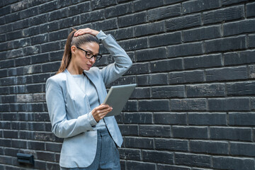 Professional woman standing confidently outside modern office building, interacting with digital...