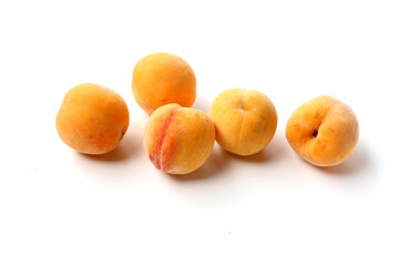 Fresh ripe apricots on a white background.