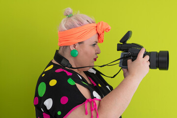 Side view of woman filming with video camera