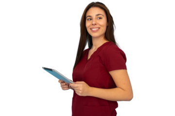 Young female nurse in maroon scrubs holding tablet and looking over her shoulder, isolated on transparent background