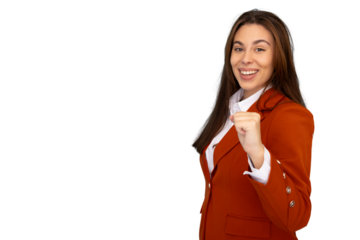 Young businesswoman in orange suit celebrating success with clenched fist, expressing joy and achievement on a transparent background