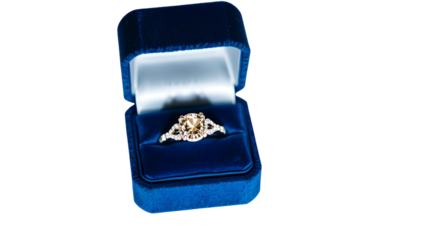 Photo of diamond engagement ring in a velvet-lined blue box isolated on transparent background.png
