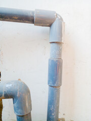 Gray pipe on the white wall. Water pipe on the white wall.