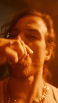 Vertical Screen: Drunk Man Walking on a Dancefloor, Drinking Shots, Making Out and Kissing a Hedonistic Female in the Middle of a Diverse Party Crowd. Joyful Hysterical Young Male Sitting Down to Rest