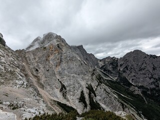 Panoramic view of Logarska dolina valley with peaks of Slovenian Alps covered by passing clouds.