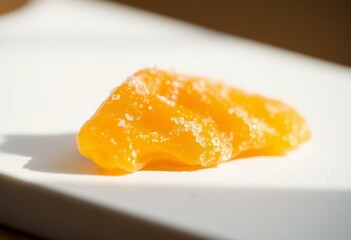 Candied ginger with sugar crystals on white background