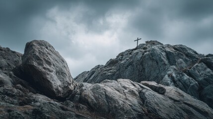 Concept photo of a rugged, rocky hill, with a small cross nestled between two boulders, reminding us of the strength and comfort that faith can bring in the face of adversity.