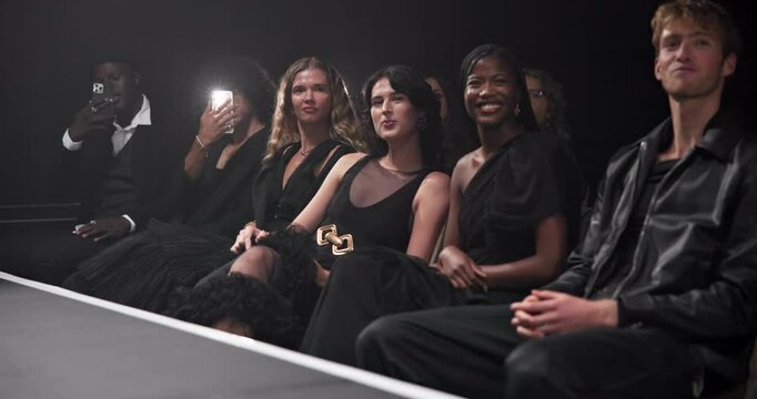 Happy people, audience and runway for fashion event, clothing inspiration or branding. Whisper, crowd or women in community with man for show, trends or row for catwalk, art or publicity on stage