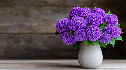 Purple hydrangeas arranged in a ceramic vase on a rustic table