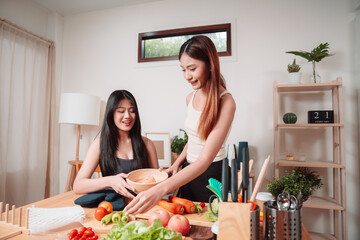 Young Women Asian Food Cooking Preparation Salad Vegetable Kitchen Lifestyle Healthy Eating, Joyful Moments of Healthy Meal Making and Togetherness in a Cozy Home Kitchen Full of Freshness and Smiles