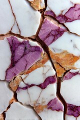 Cracked Calacatta Viola marble surface with purple veins and golden details in closeup composition
