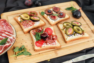 Toasted white bread with labneh, prosciutto, salami, figs, cherry tomatoes, basil, pumpkin seeds. Savory toast variation perfect for brunch or appetizers