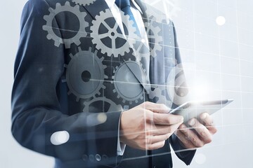 Businessman Holding Tablet with Gears Overlay Representing Digital Process Automation