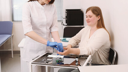 Doctor does a finger prick blood test for sugar. Diagnosis of diabetes, insulin resistance, excess...