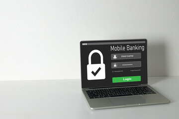Laptop displaying a secure mobile banking login screen with a padlock icon.Concept for online banking security,digital finance protection,secure access to account,and financial technology.