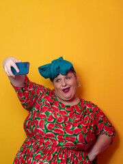 Confident plus-size woman taking selfie with smartphone